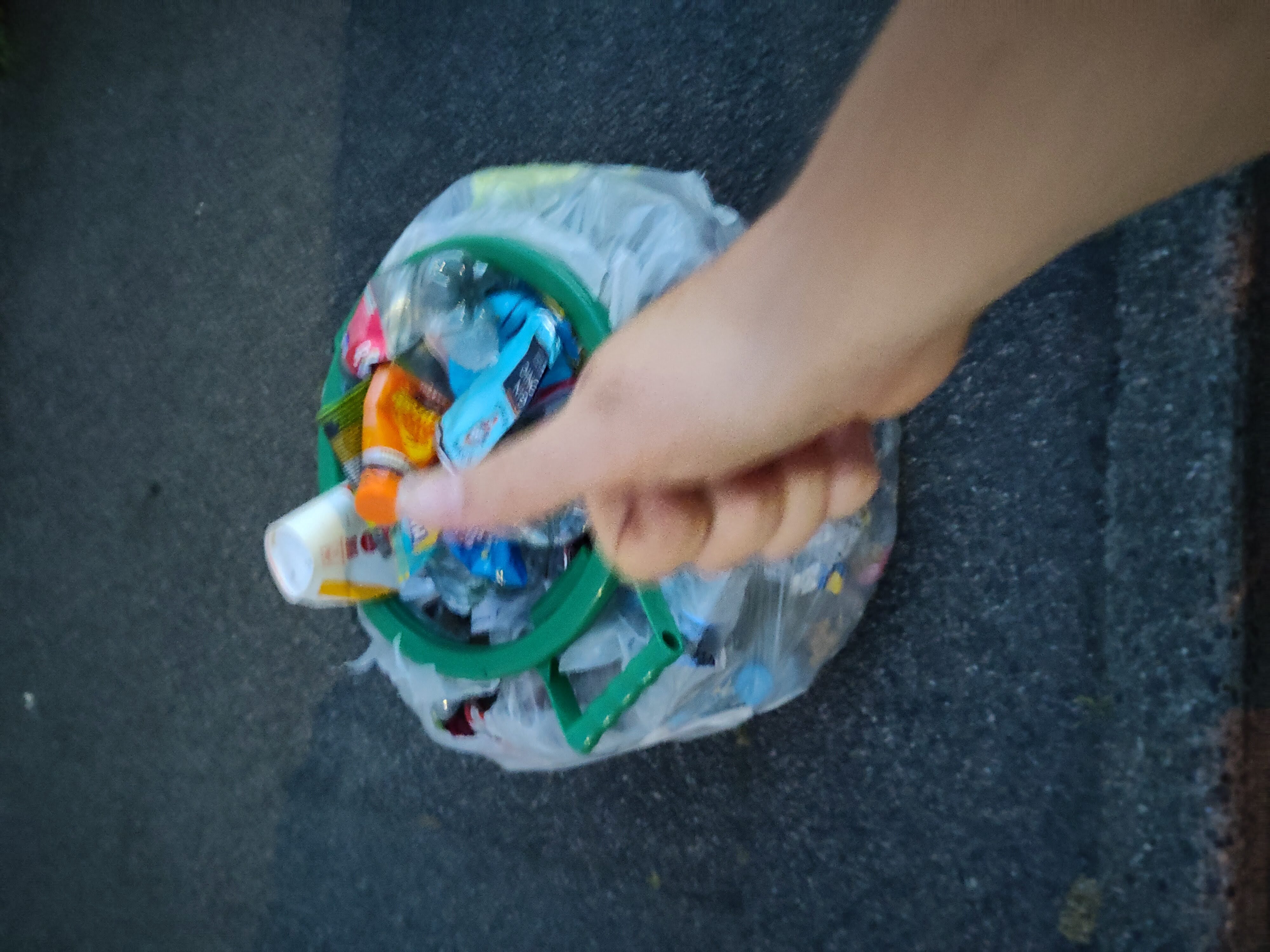 A side on image of a bag full of litter with a thumbsup next to it