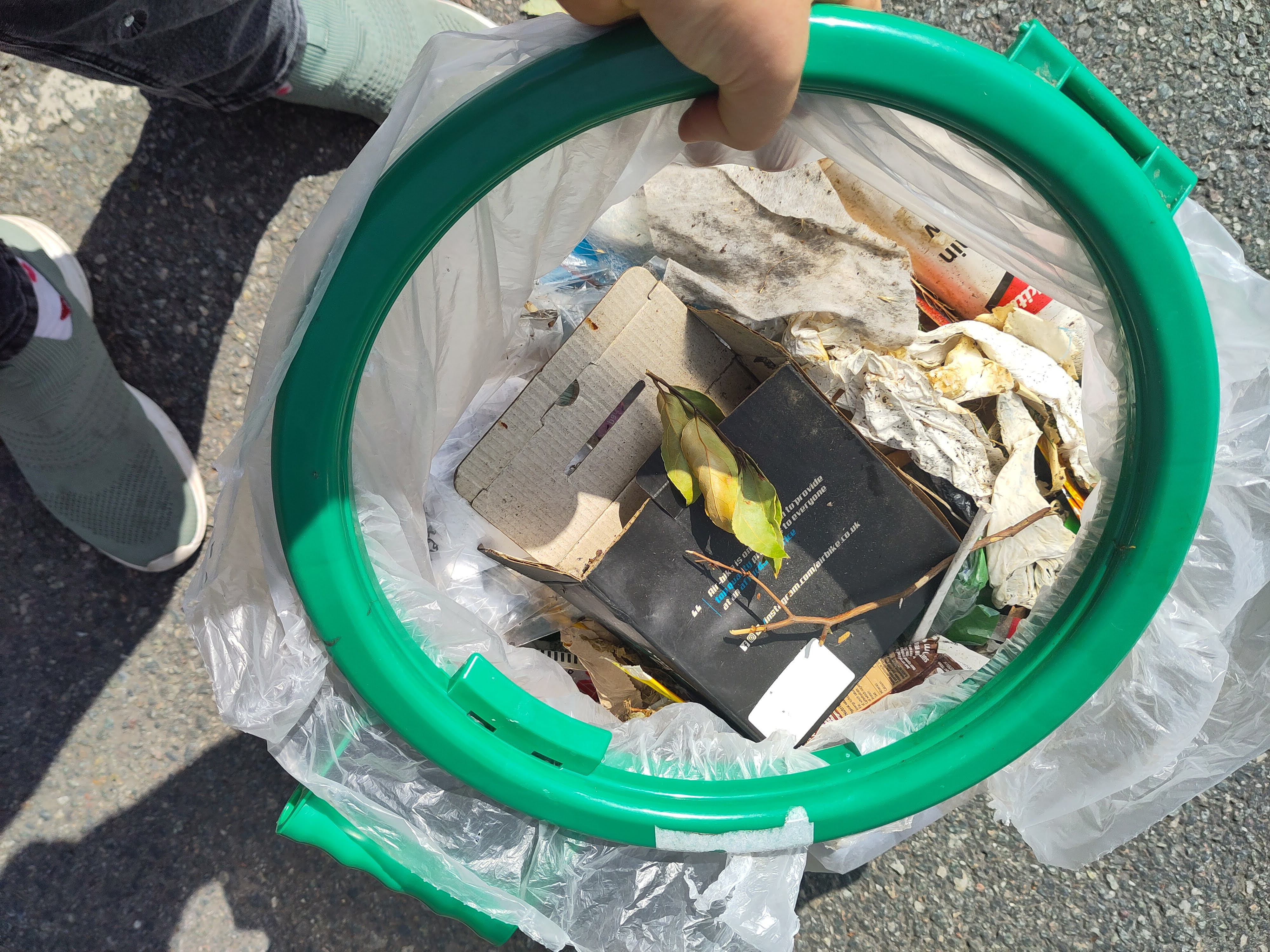 A side on image of a bag full of litter collected arround the town